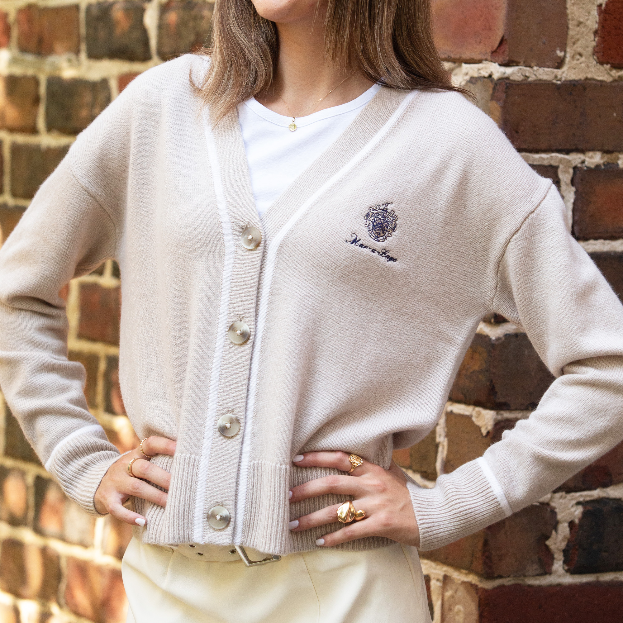 Female model wearing the Ladies Mar-a-Lago Cashmere Cardigan in the colors toasted and sea salt Female model wearing the Ladies Mar-a-Lago Cashmere Cardigan in the colors toasted and sea salt